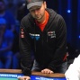 Daniel Negreanu stands as he watches his bracelet hopes disappear