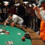 Ray Foley reacts to a winning flop as Brandon Cantu looks on