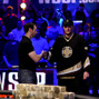 Brian Rast shakes Phil Hellmuth's hand.