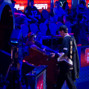 Phil Hellmuth is greeted by a fan as he makes his exit from the WSOP Main Event 2011