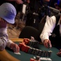 The dealer counts the chips of Aleksandr Mozhnyakov as he goes all in.