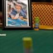 A portrait of Dr. Jerry Buss sits on the table next to an honarary stack of chips for $2500 Seven Card Stud Event at the WSOP.