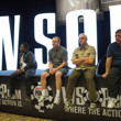 People hanging on the rail of the WSOP sign in the Pavilion Room