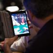 Matt Glantz takes a photo of Phil Hellmuth on his iPad Mini