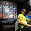 Antonio Esfandiari sitting beneath the photo of him from The Big One for One Drop