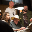 Todd Brunson & Gregg Mueller over railing the table of Doyle Brunson