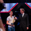 Thomas Lamatsch hands Philipp Gruissem his High Roller Winner's Trophy