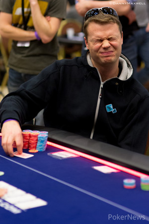 Juha Helppi grimaces when shown the winning hand