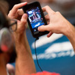 Jason Mercier takes a photo of Liv Boeree eating a giant cupcake