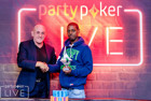 Leon Campbell collects the Side Event trophy from Dusk Till Dawn and poker legend Simon Trumper