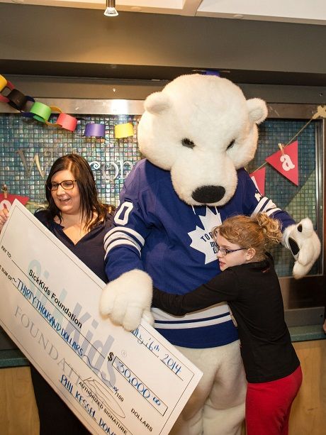Toronto Maple Leafs' mascot Carlton the Bear presents Phil Kessel's $30,000 donation to SickKids Foundation.