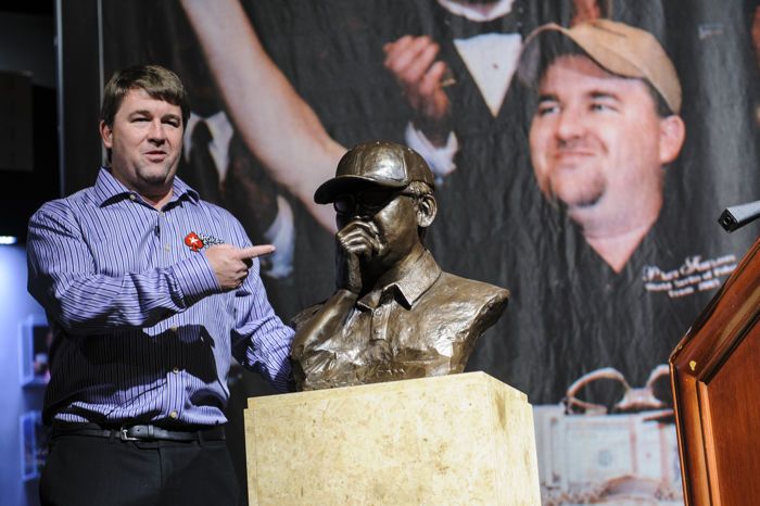 Chris Moneymaker posing with the commemorative bust