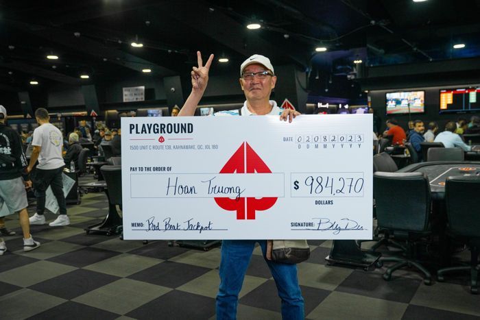 Hoan Truong holds up the bad beat jackpot check