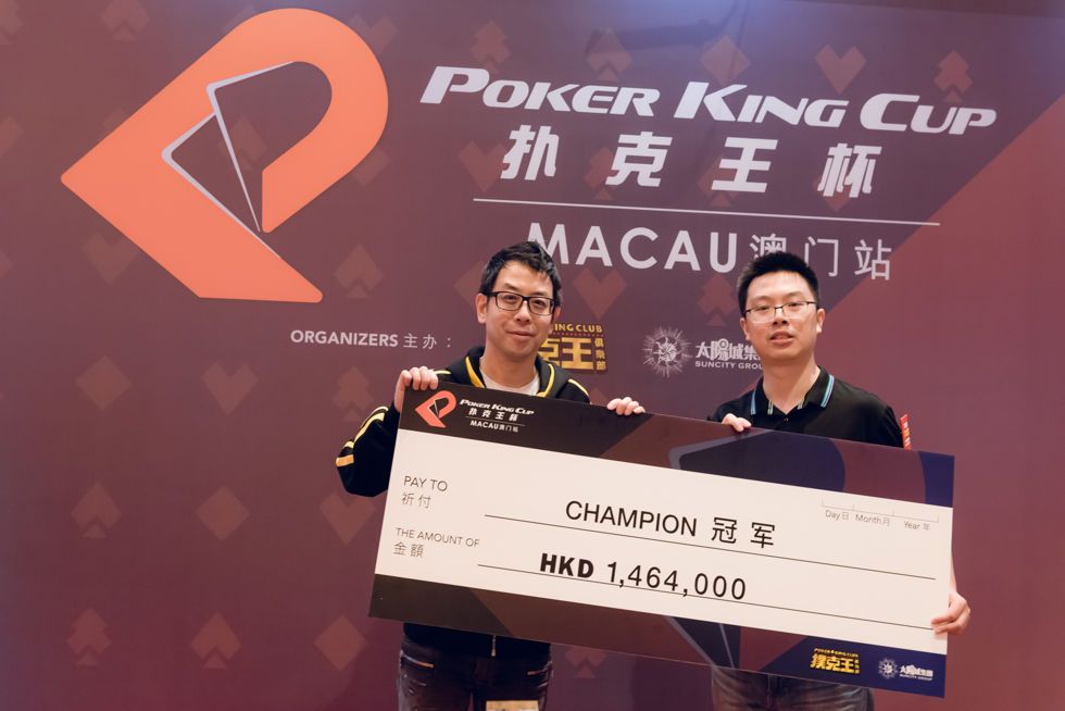 Poker King Cup President Winfred Yu (left) awards PKC Champion Wei Ran Pu with his winner's cheque
