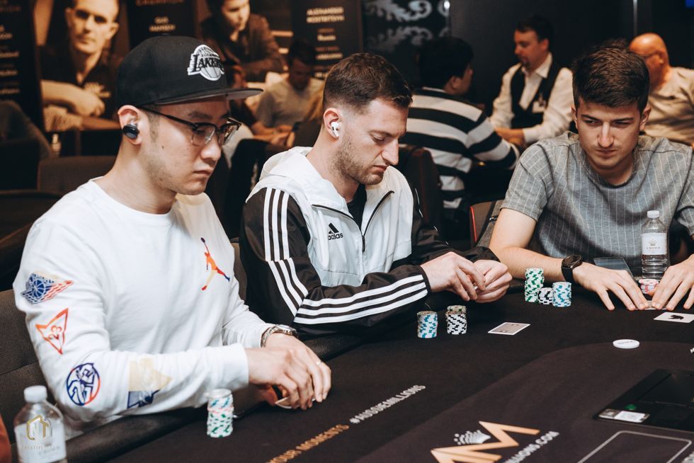 Joey Weissman at a tough Opening Event table, seated between Jamie Lee and Dzmitry Urbanovich